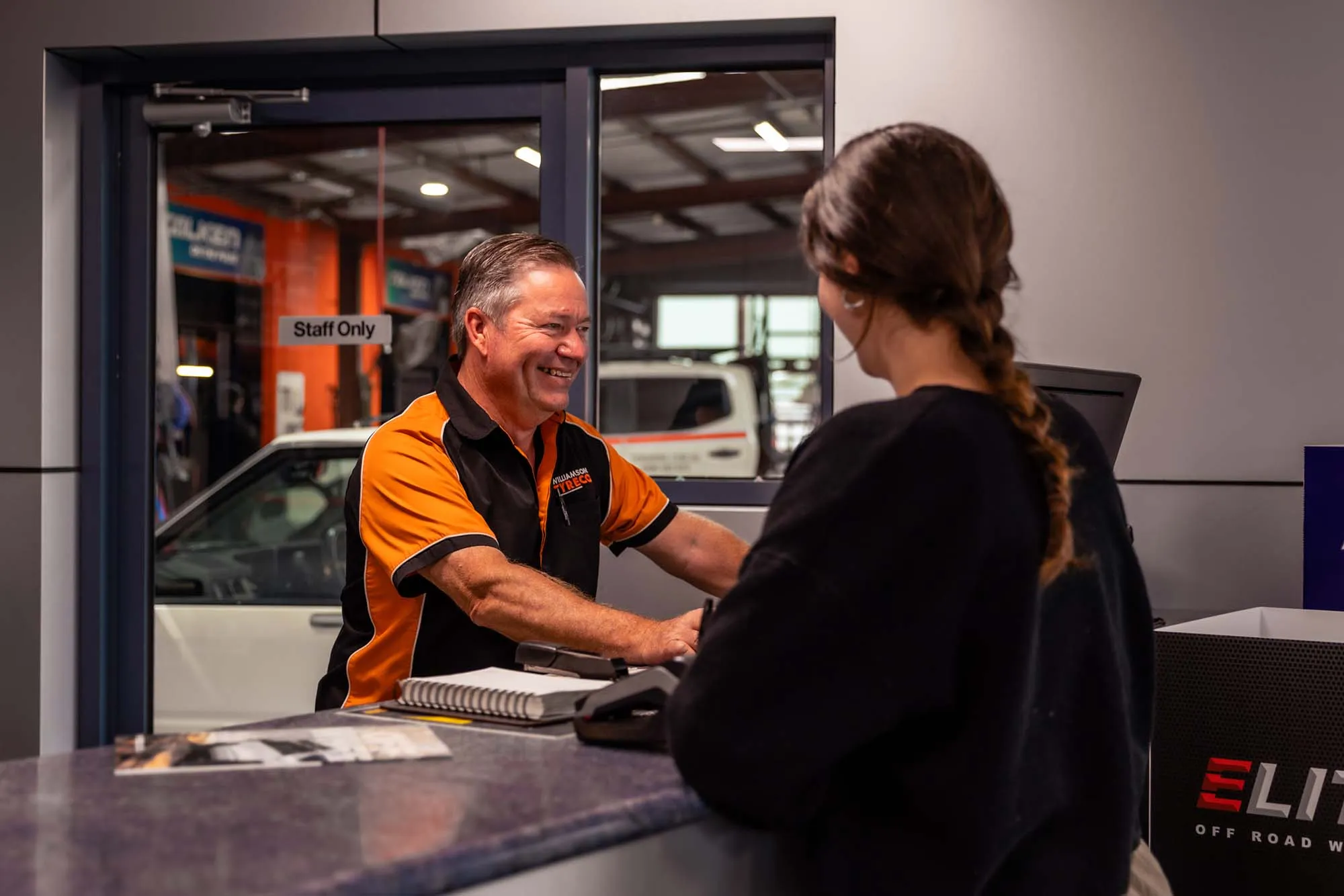 A Williamson Tyreco team member serving a customer at the counter
