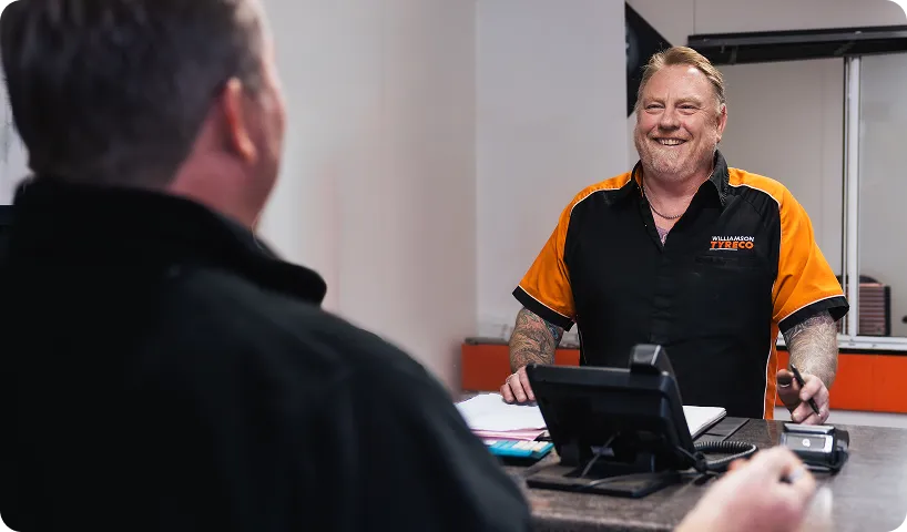 A Williamson Tyreco team member serving a customer at the counter